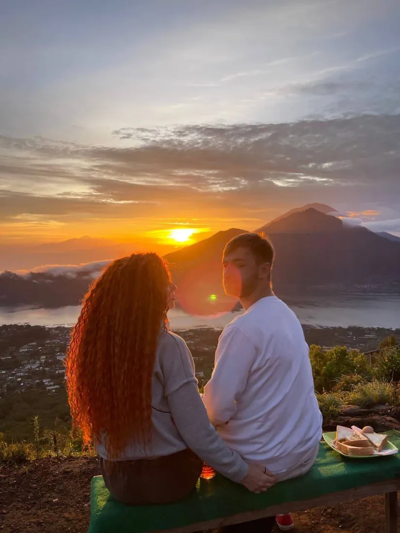 Couple watching sunrise over Mount Batur volcano